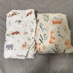 Set of two woodlands themed crib sheets